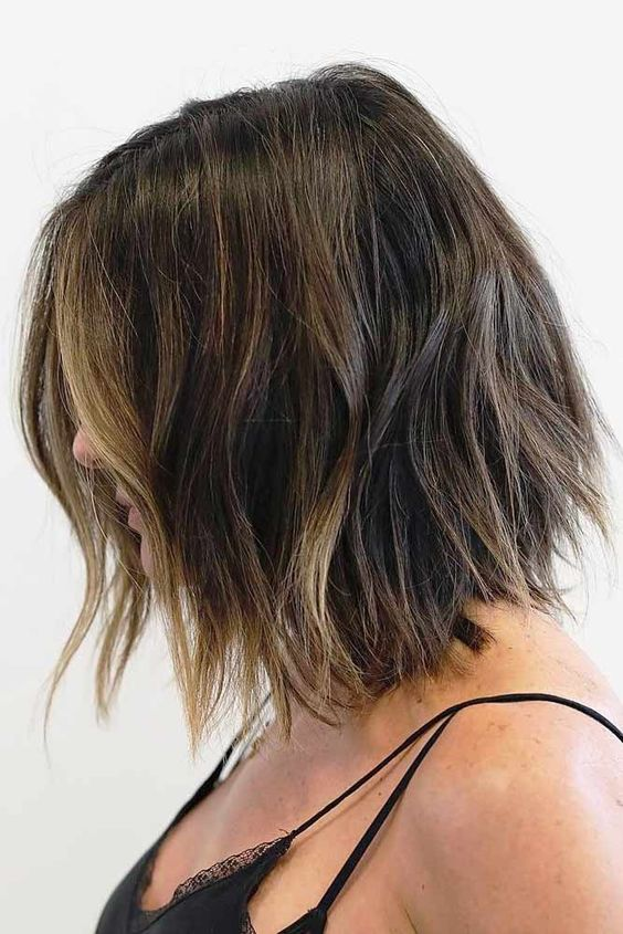 Side view of a lady wearing the shoulder skimming shears cut