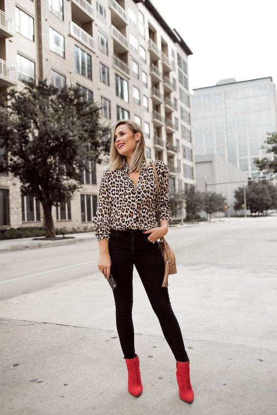 Wearing a leopard top, black pants, and red boots creates an attractive look