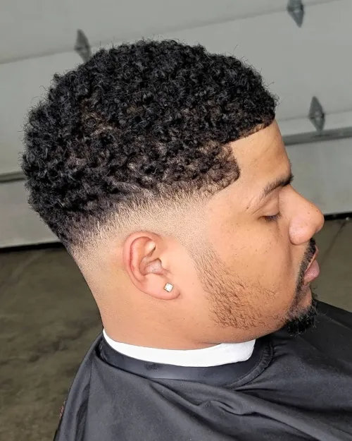 Picture showing a guy with a textured hair  rocking the french crop
