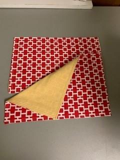 A folded cloth with a yellow corner

Description automatically generated