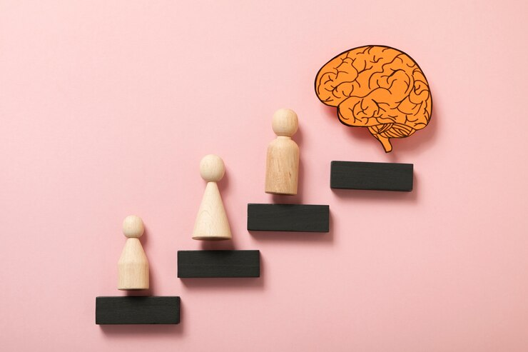 Wooden pawns surround a paper brain.