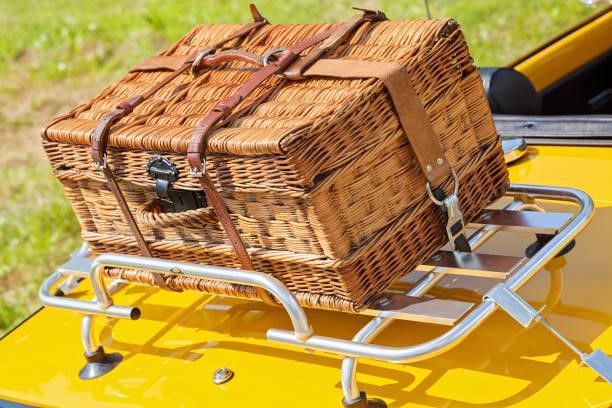 suitcase for a picnic suitcase for a picnic on the trunk of yellow car, note shallow depth of field Roof basket for your road trip stock pictures, royalty-free photos & images