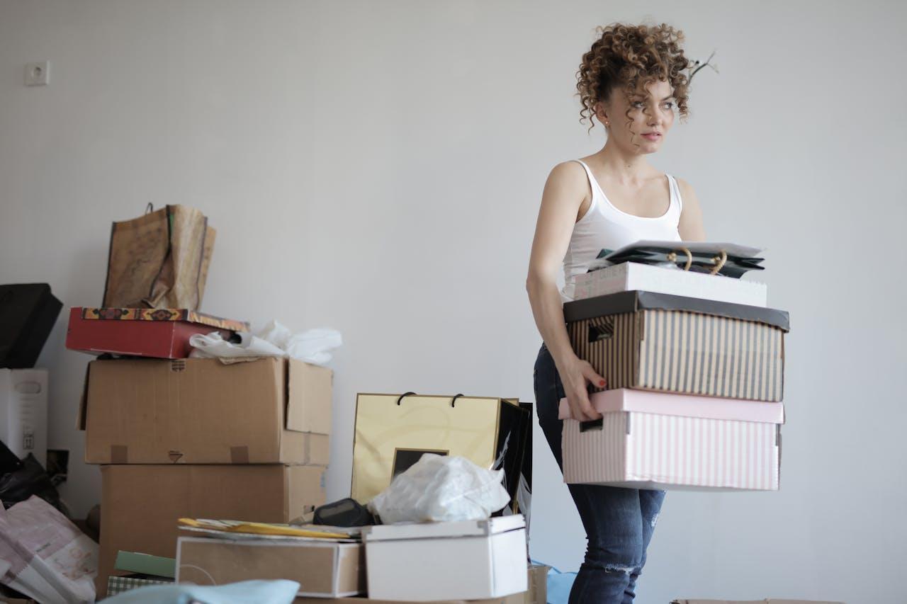 a woman carrying boxes in a room