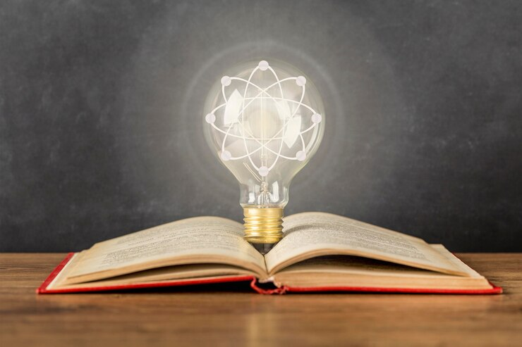 An open book with a lit bulb on top, symbolizing philosophical concepts.
