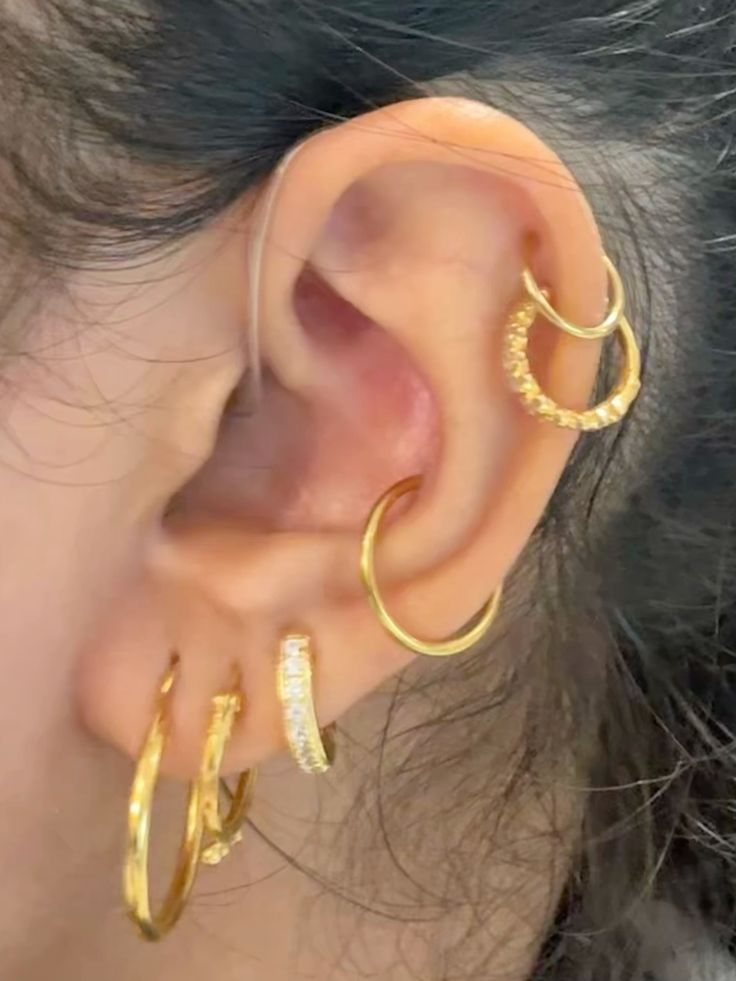 Picture of a girl rocking two gold blings for  her cute piercing
