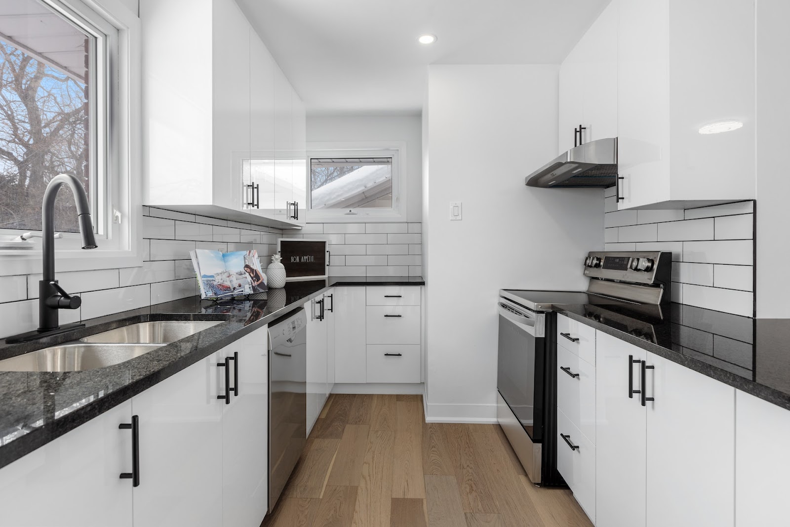 How To Clean Quartz Countertops - a black and white kitchen with quartz countertop