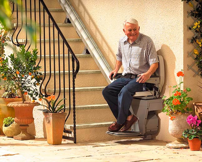 A gentleman using the outdoor Stannah Sadler stairlift