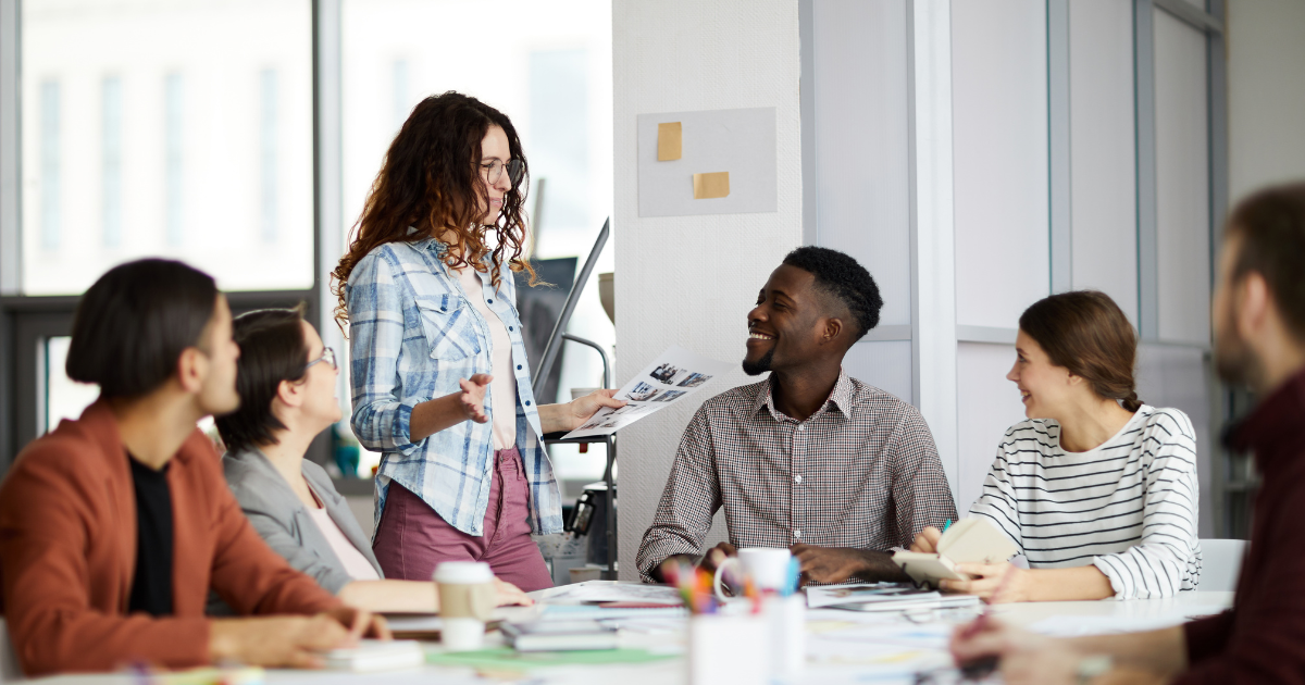 Group of professionals in a meeting, guided by an agile enterprise coach.