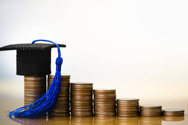 graduation-hat-on-coins-money-on-white-background-picture-id1162366190?k=20&m=1162366190&s=612x612&w=0&h=wCWq4esmYtPa1wsCCc1hgnAfENFlkHeaCgbYnase1cQ=