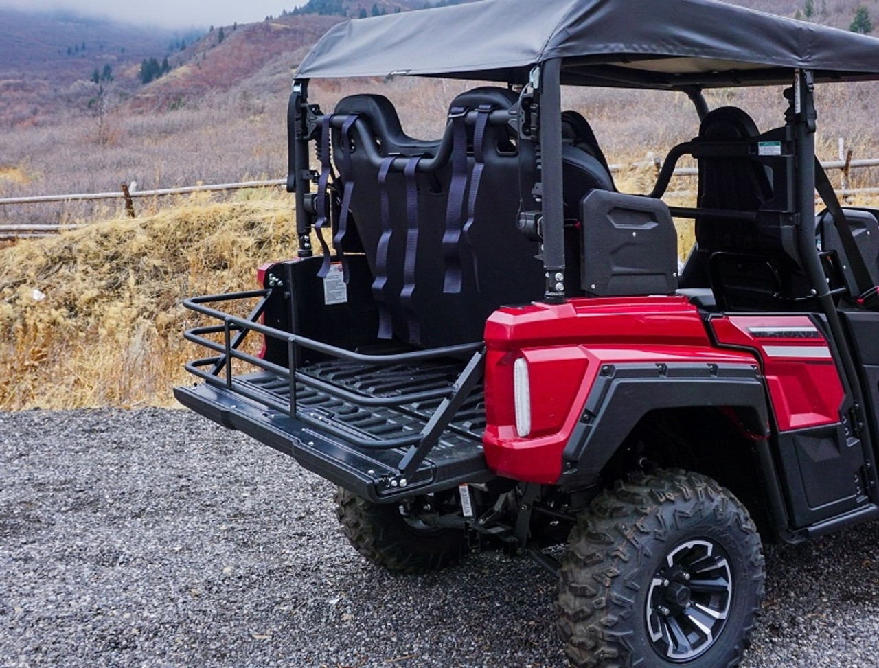 An image of the Yamaha Wolverine X4/Rmax4 Bed Extender by UTV Mountain Accessories, installed on a UTV that is parked on a gravel trail.