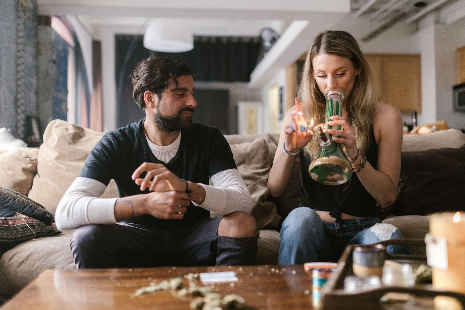 a couple smoking weed from a bong