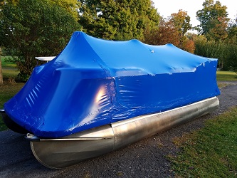 Pontoon winterized in blue boat shrink wrap