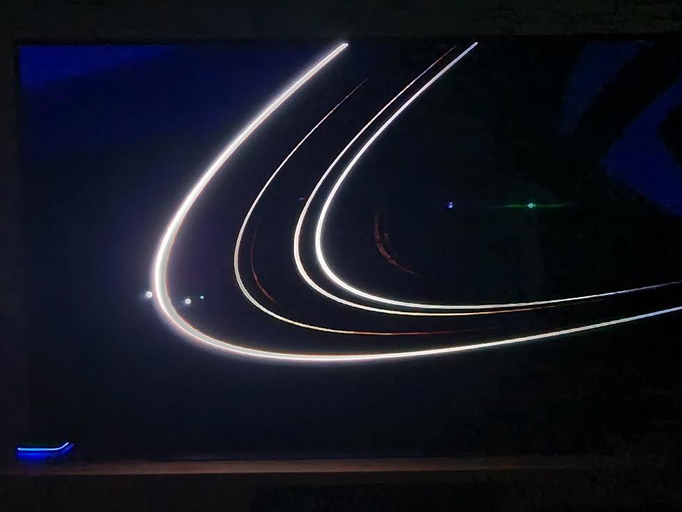 A light trails in the dark

Description automatically generated