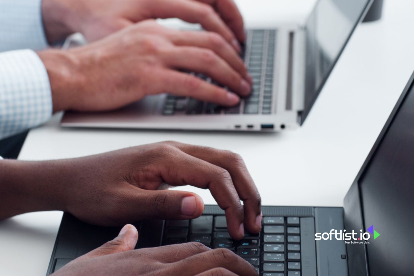 hands typing on their laptops