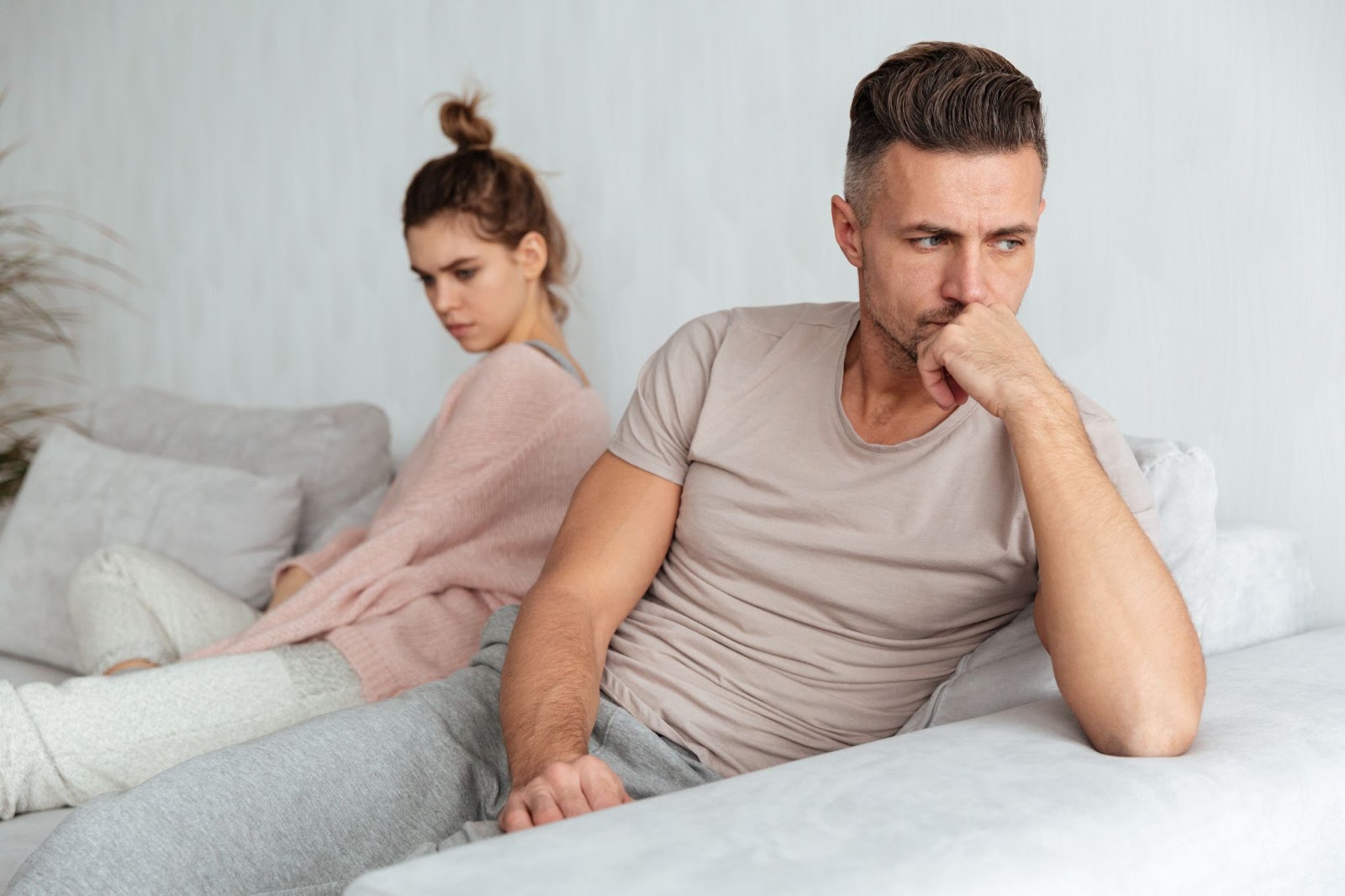 Man and woman sitting on a couch after an argument