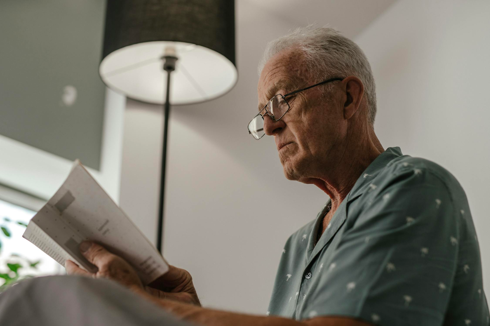 a senior man reading a book