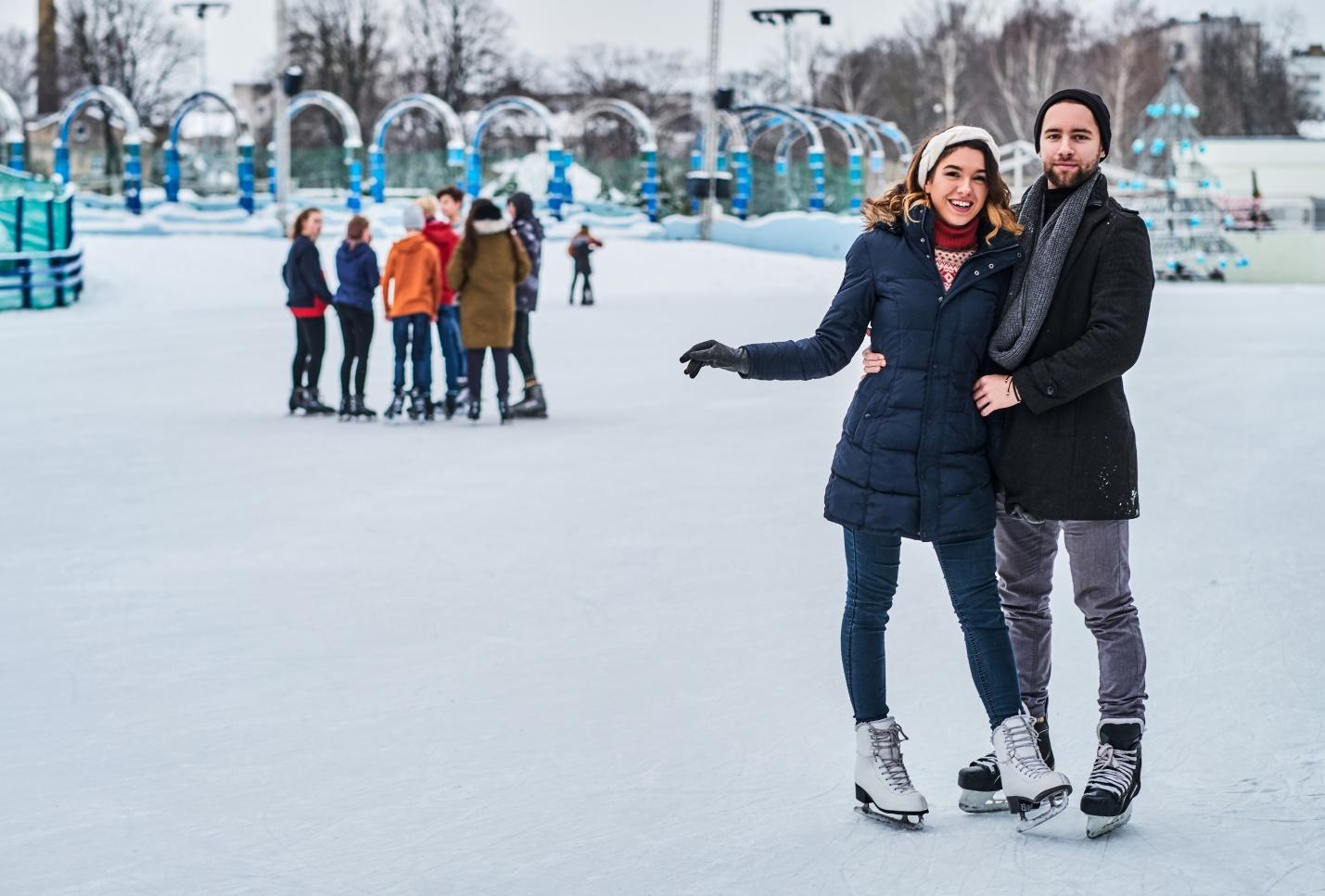 happy-young-couple-dating-ice-rink-hugging-enjoying-winter-time
