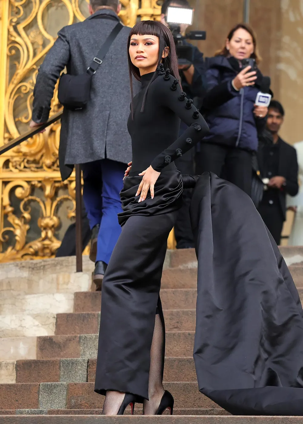 Picture showing Zendaya at the steps of the Paris Haute Couture Week 2024 in a stunning black gown and train