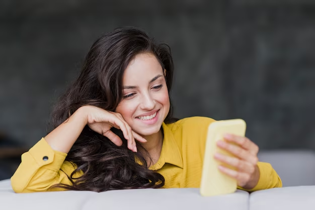 Woman laughing as she browses funny bio quotes on mobile.