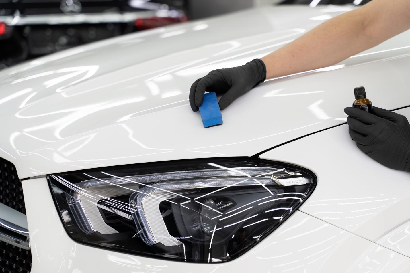 Coating a white car's hood.