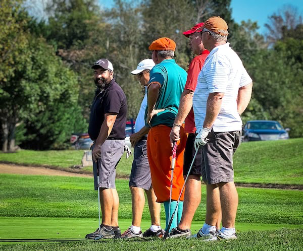 five golfers in a group
