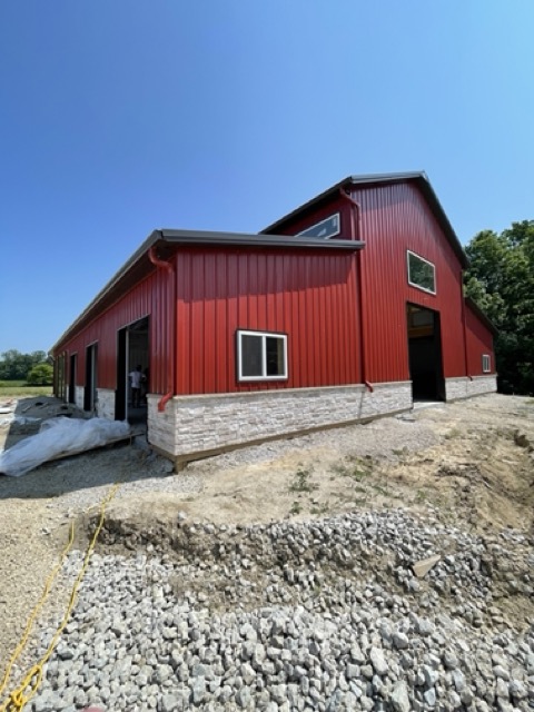 red monitor stlye pole barn with stone wainscoting