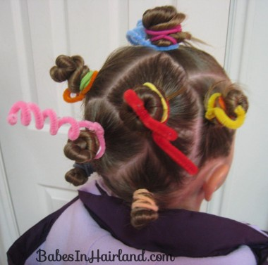 Picture of a girl rocking bantu knots with ribbon for the event