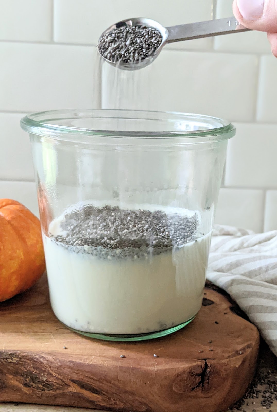 close up of chia seeds being added to hot milk