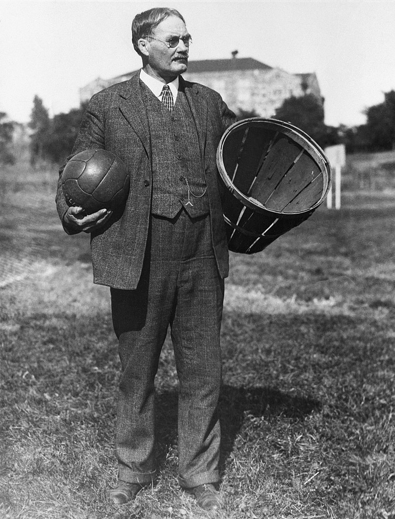 James Naismith with a soccer ball and a basket.