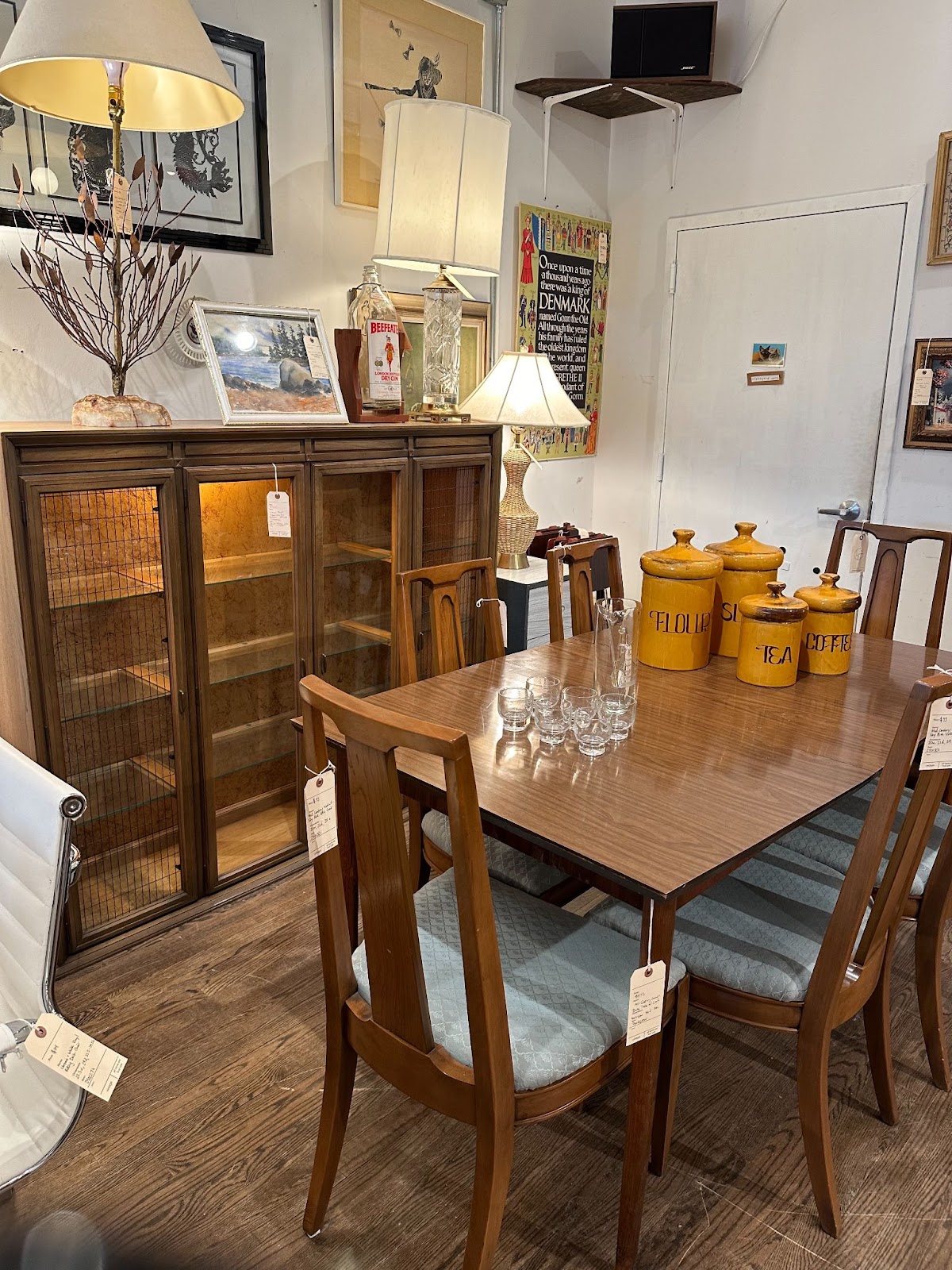 A vintage kitchen table and chairs with flour, sugar, tea, and coffee containers for sale