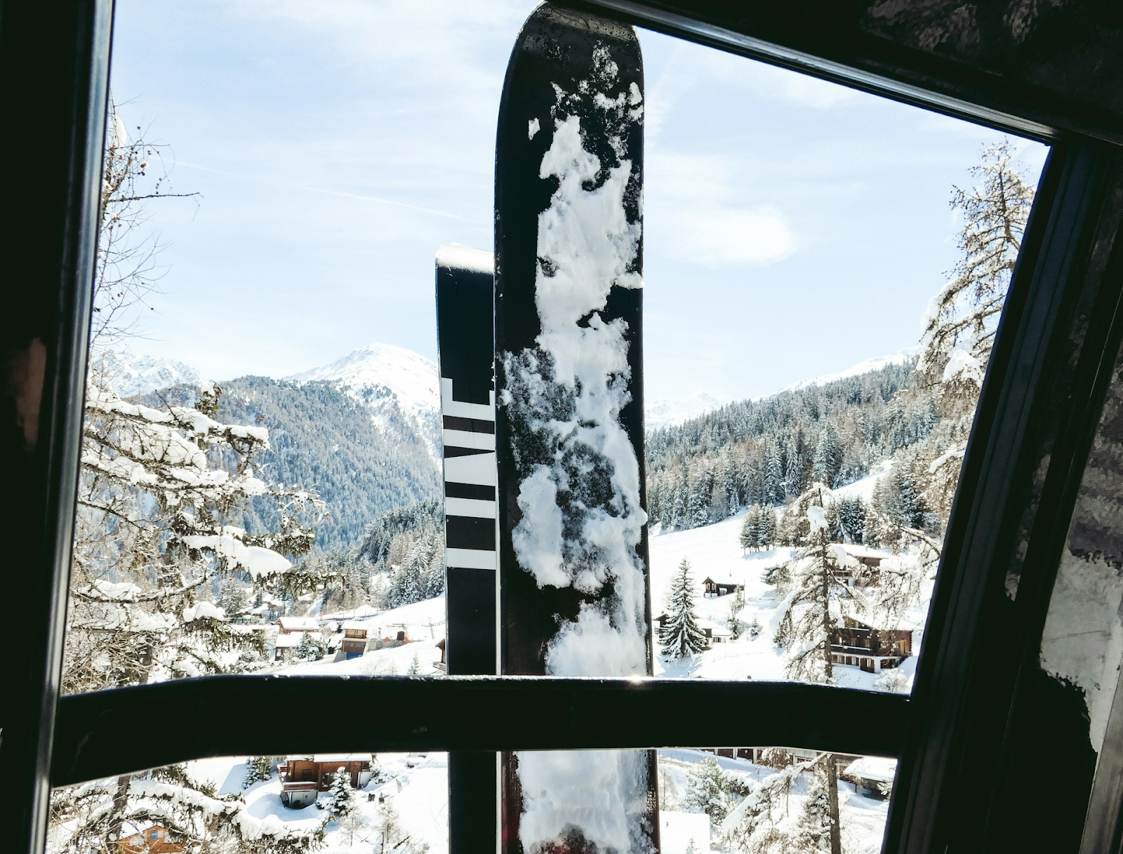 Two snowboards leaning on the window