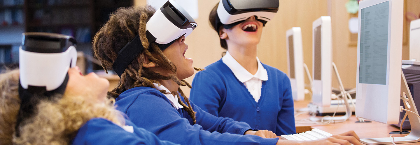 children wearing virtual reality headsets with delighted expressions.