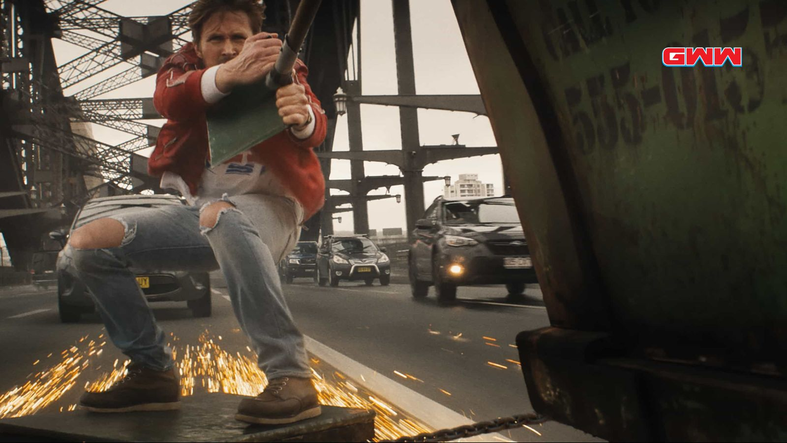 Stuntman on bridge with sparks in The Fall Guy movie trailer