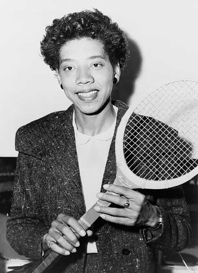 spotcovery-Althea Gibson holding a tennis racquet.