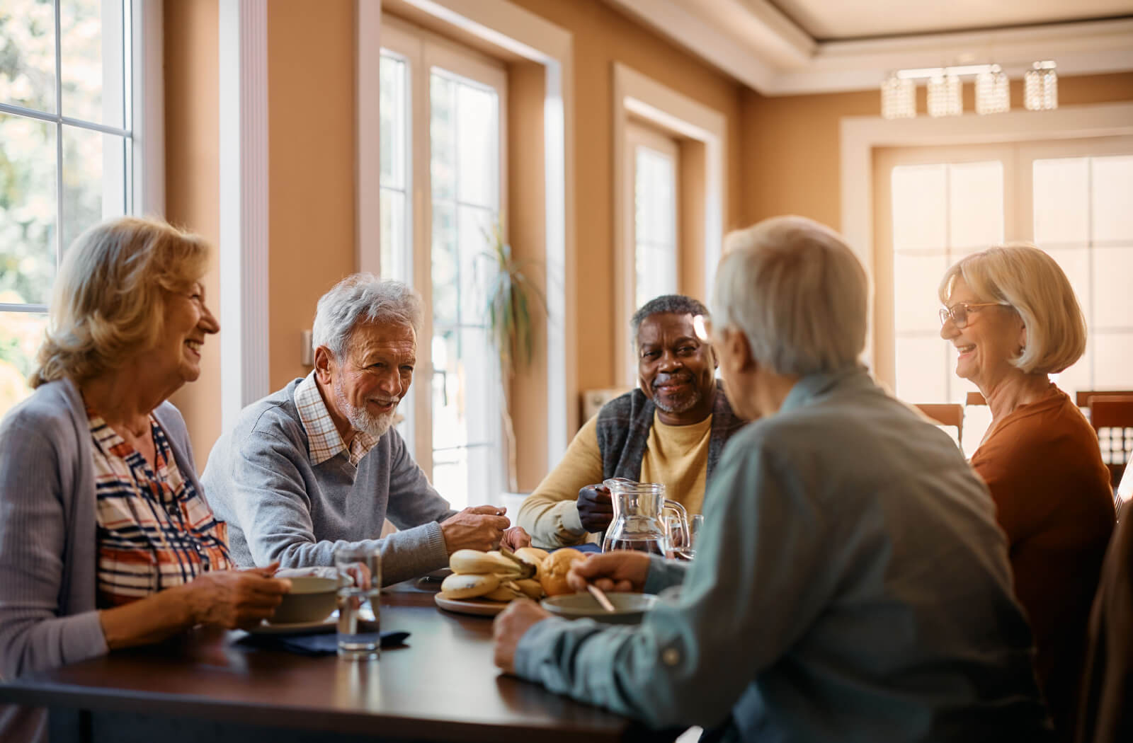 Group of seniors sitting around a table enjoying breakfast.