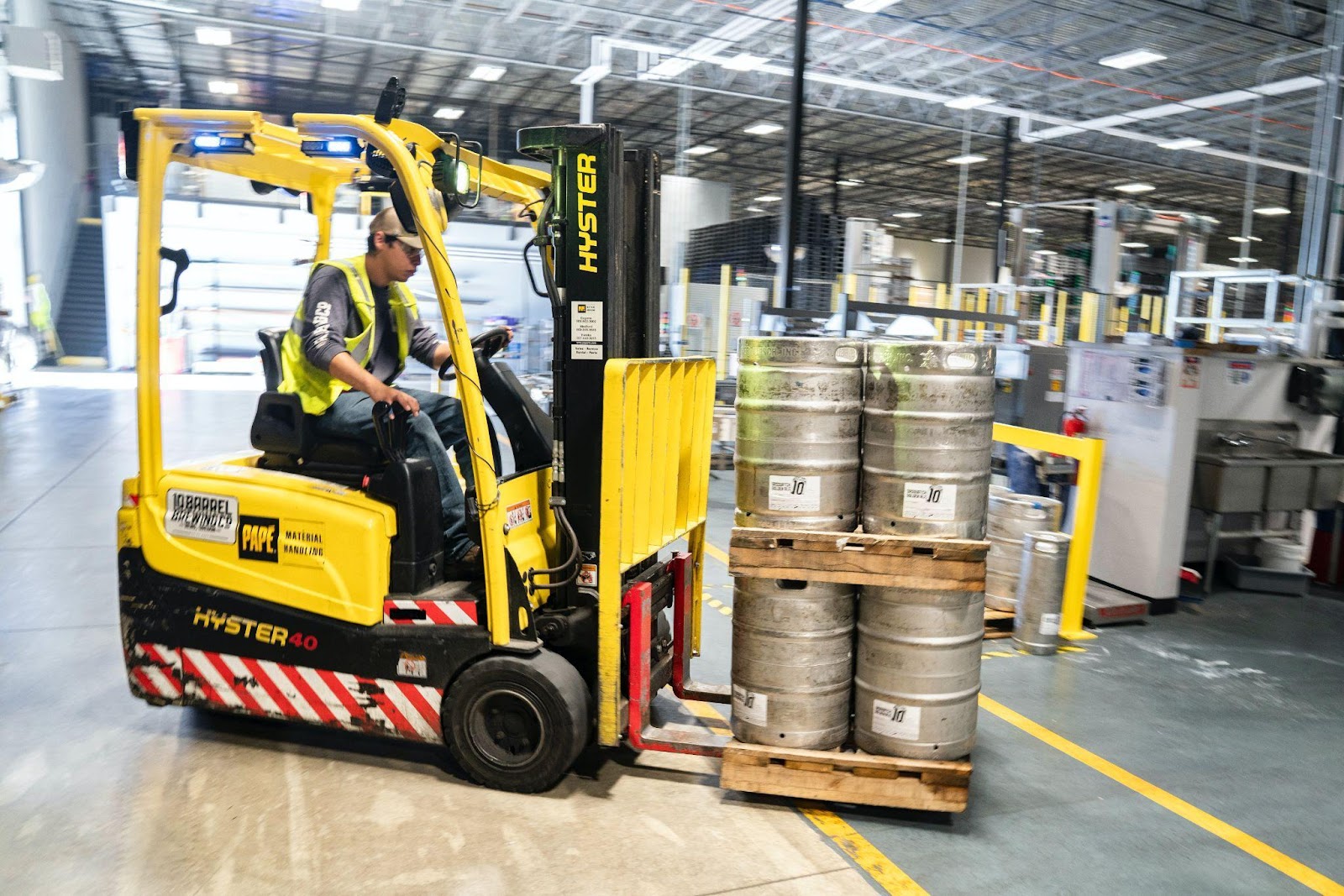 a man driving a forklift in a warehouse