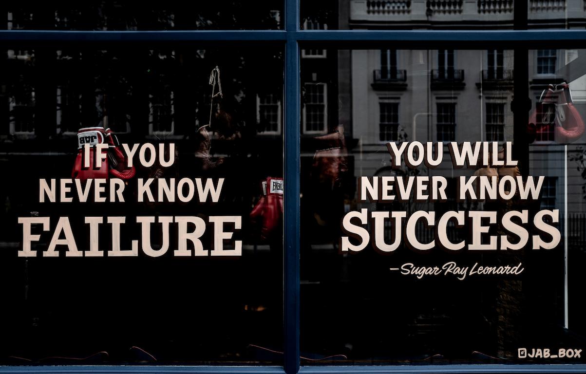 A quote from sugar ray leonard on a window that says "if you never know failure, you will never success," which is a common theme of inspirational sports speakers.