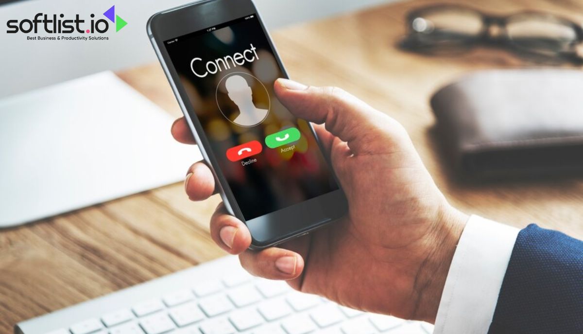 Hand holding smartphone with incoming 'Connect' call on screen over office desk