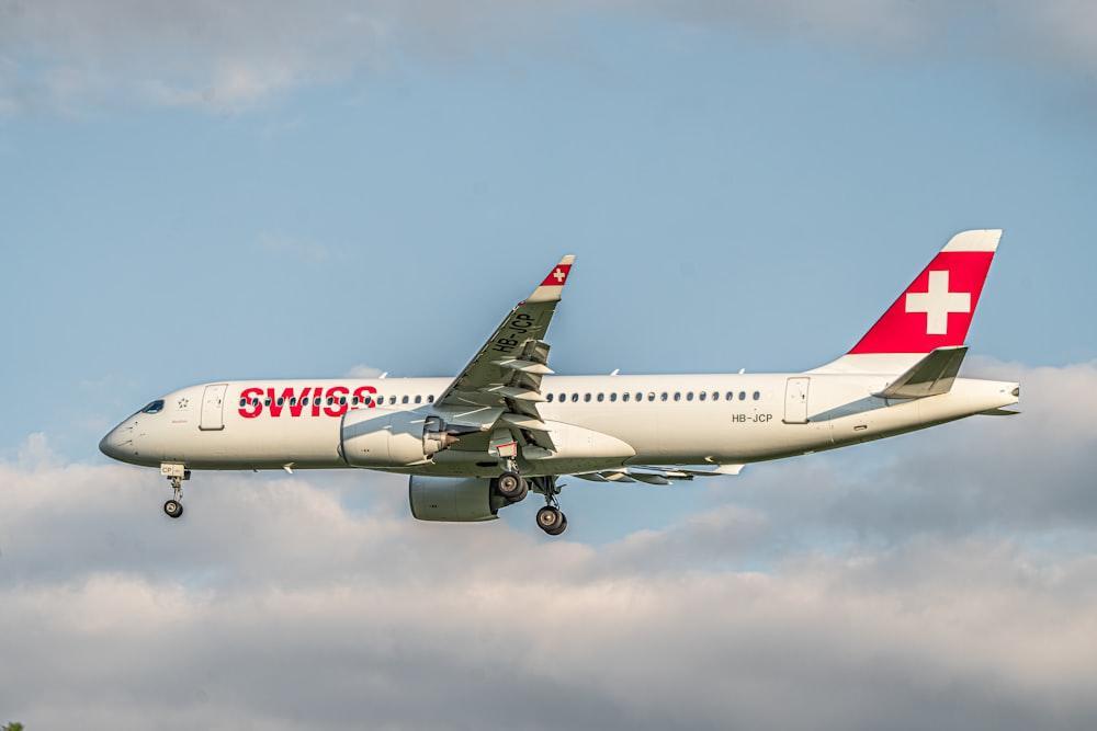 a large passenger jet flying through a cloudy sky