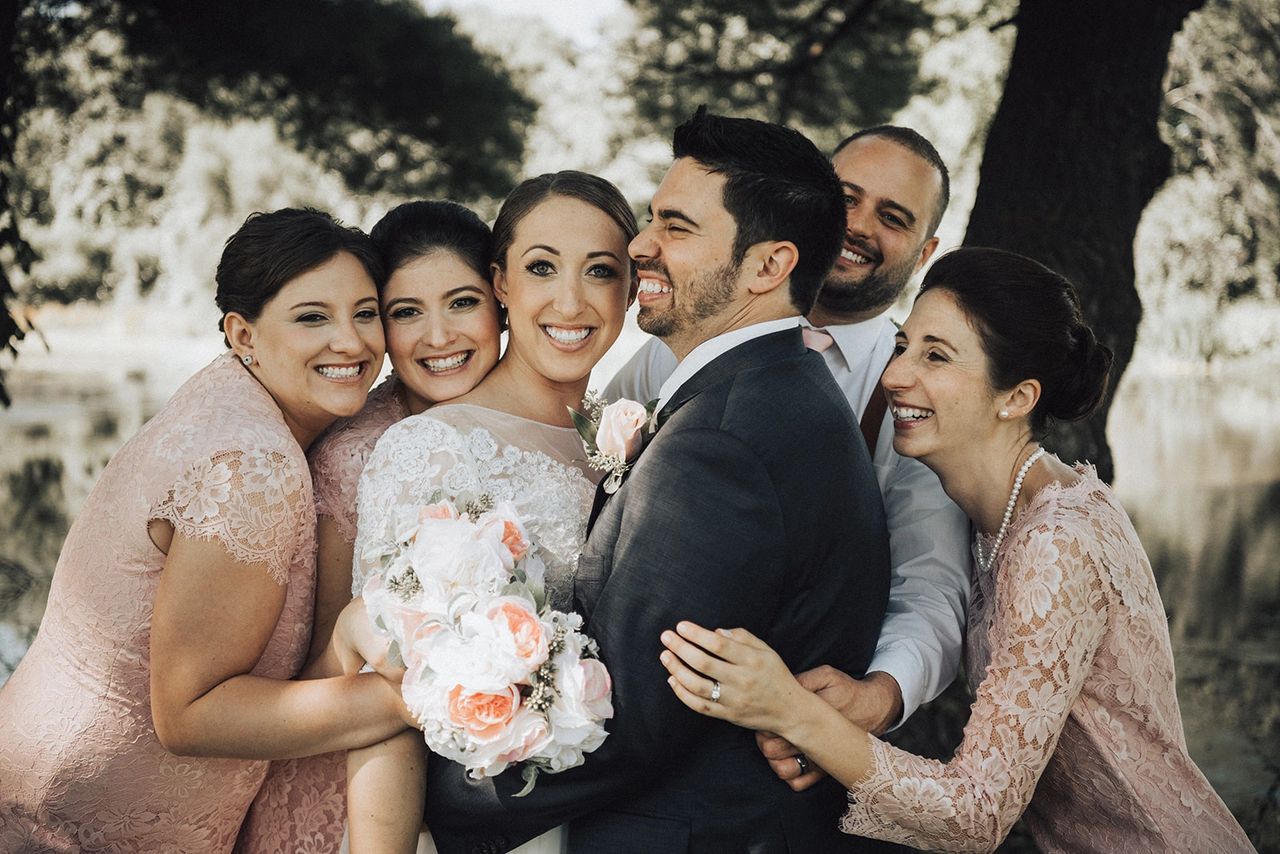 Bride and Groom getting hugged by wedding guests