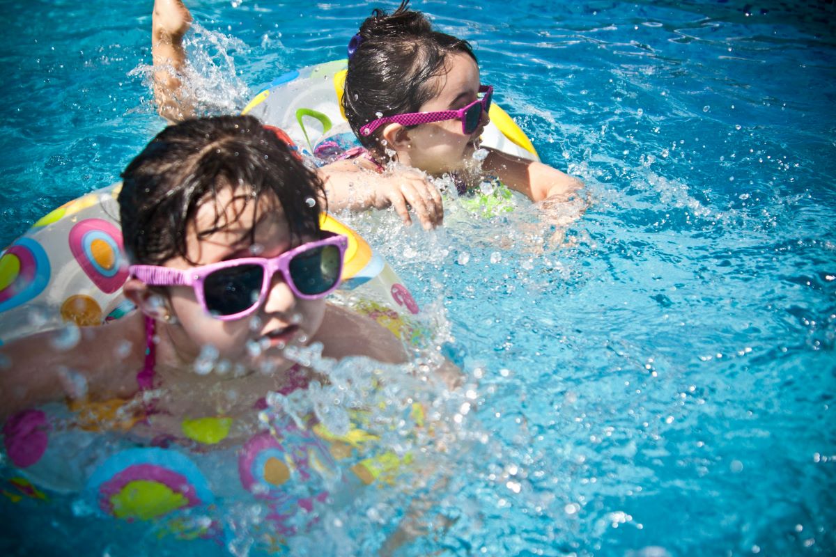 two toddlers enjoying swimming