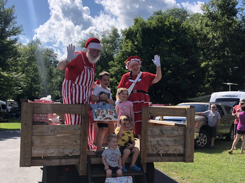 Wagon ride at a campground with Santa and Mrs. Clause surrounded with kids - camping at Christmas