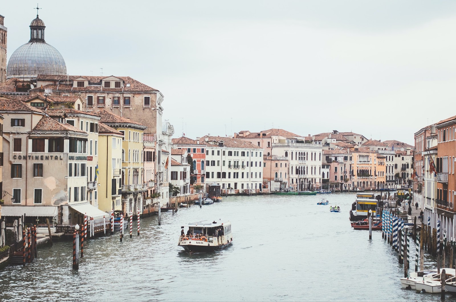 Breathtaking views of Venice's Grand Canal with a vaporetto enjoying the scenery. 