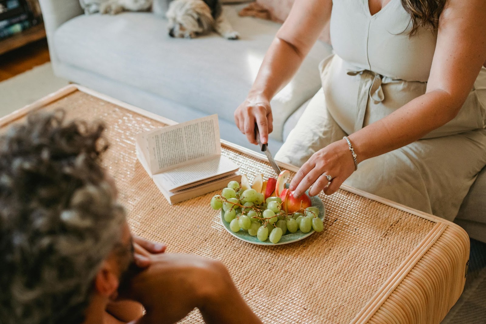 pregnant woman cutting fruits