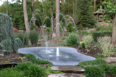 top water features to install for your outdoor living space splash pad installment in backyard custom built michigan