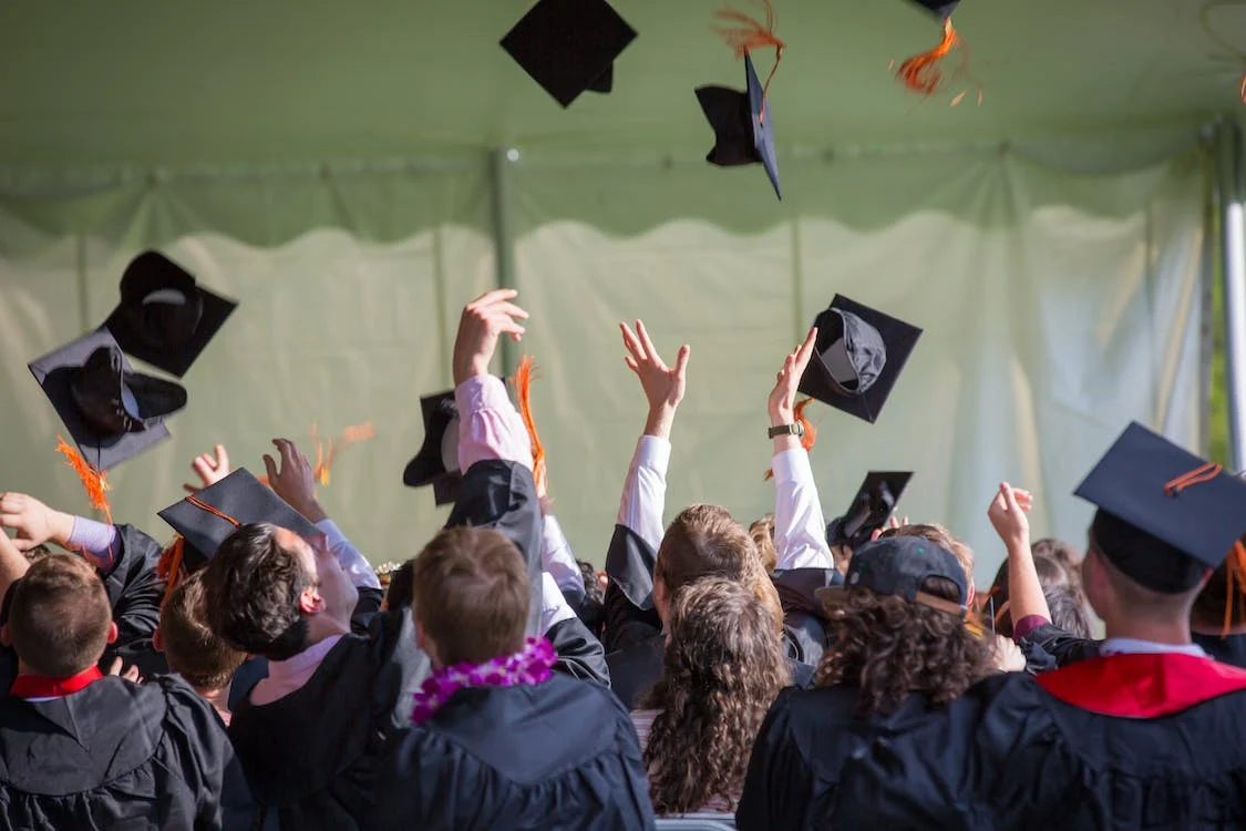 English Masters Degrees in Bulgaria: A Comprehensive Guide Article Main Image Showing Masters Students Tossing Their Caps