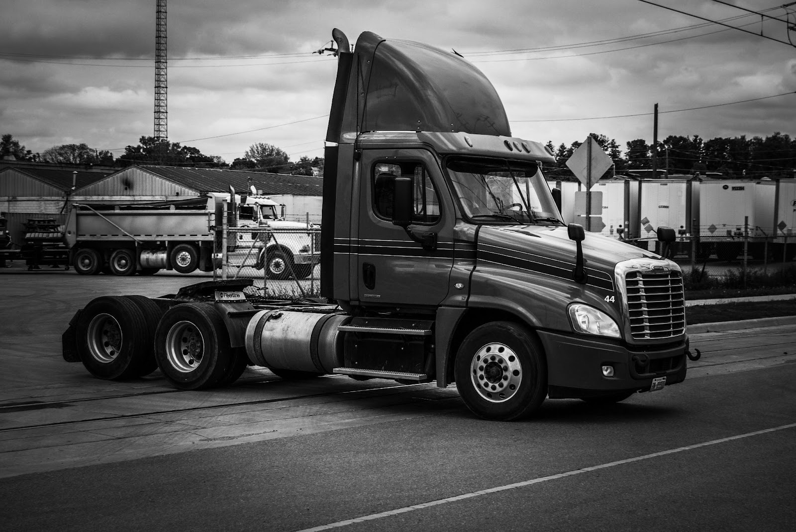 A day cab semi truck in a black-and-white style photo