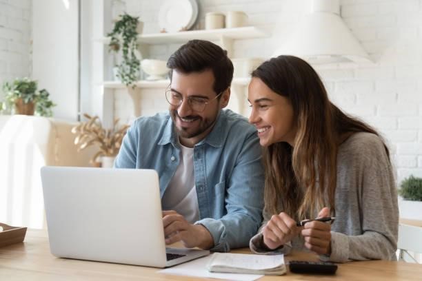 https://media.istockphoto.com/id/1197547531/photo/happy-young-couple-paying-bills-online-in-computer-app.jpg?b=1&s=612x612&w=0&k=20&c=t6jUduMrM0M56ReXI2hUfIoovuiQ9Te-TvNwbnfwCxc=