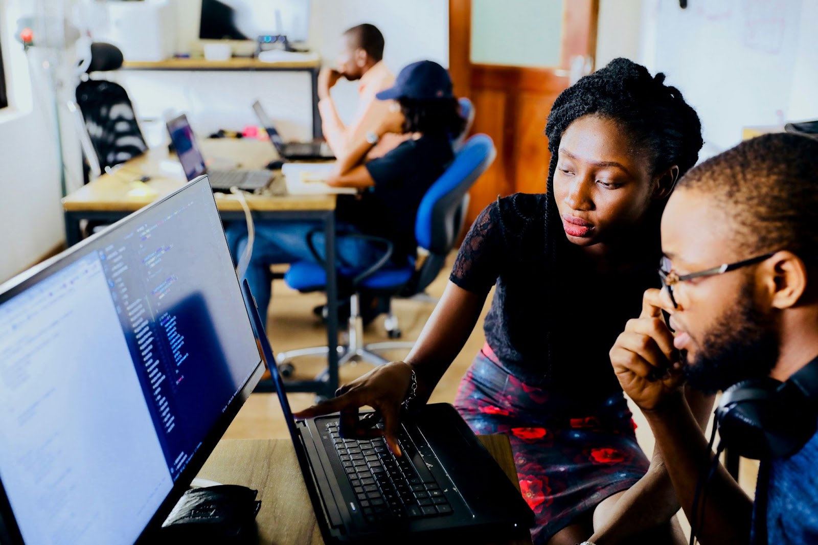 Two people looking at a computer