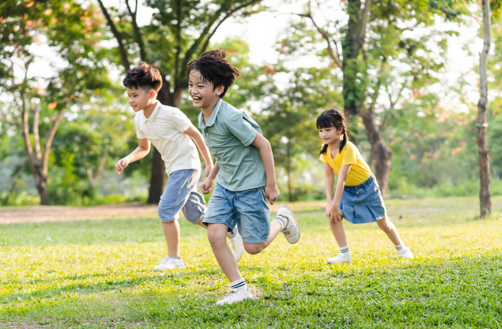 A group of children playing and running outdoors.